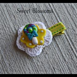 crochet flower hair clip topped up with polymer clay bead 