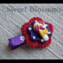 crochet flower hair clip topped up with polymer clay bead 