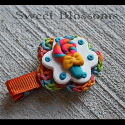 crochet flower hair clip topped up with polymer clay bead 
