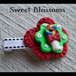crochet flower hair clip topped up with polymer clay bead 